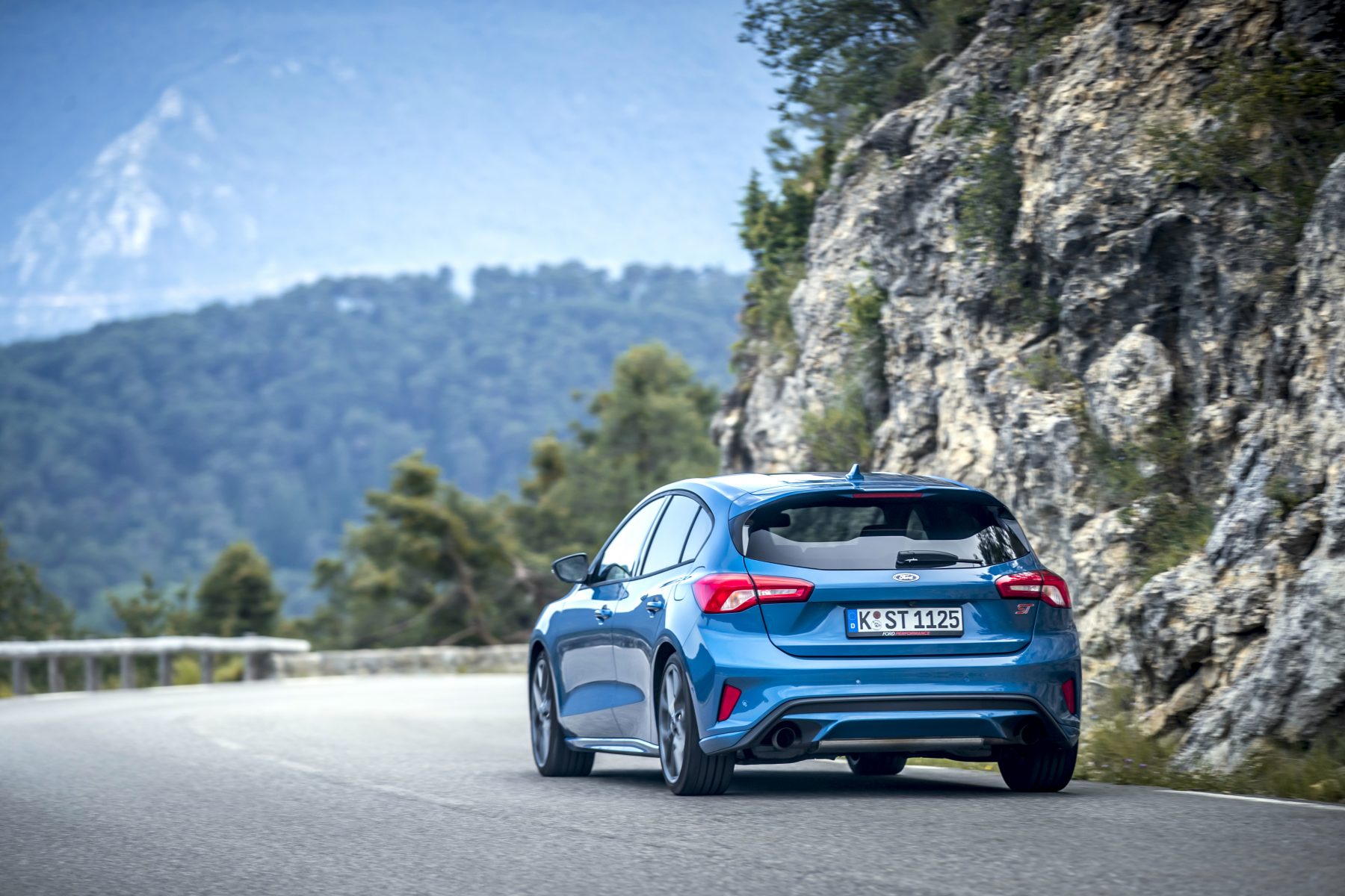 Rear view of Ford Focus GT next to  a mountain